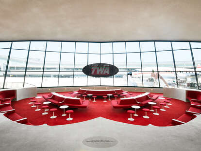 The Sunken Lounge at the TWA Hotel features a split-flap exit panel by Solari di Udine and a view of the Lockheed constellation