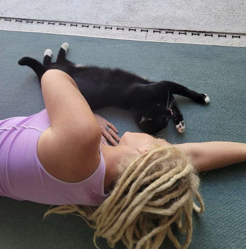 woman and cat on floor