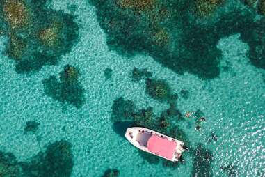 aerial view of boat in blue clear water