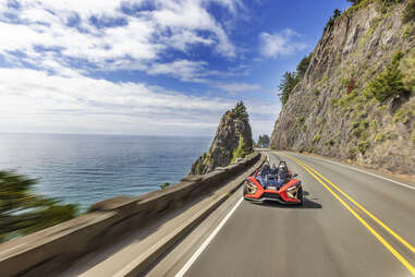 slingshot on a freeway on the coast