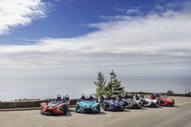 slingshots parked side of the road looking at ocean