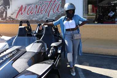 person standing next to slingshot with helmet on