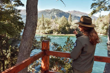 guide pointing at river