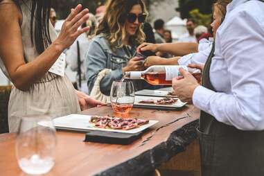 person pouring wine