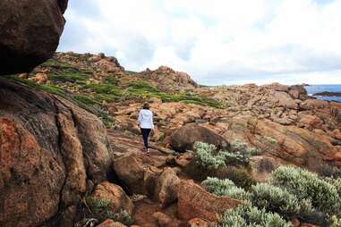 person hiking on rocky path