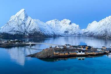 a fishing village in the shadow of an enormous mountain