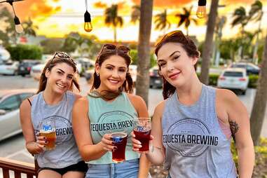 Women Holding Tequesta Brewing Beers