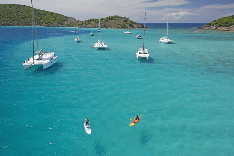 snorkeling in a beautiful bay surrounded by boats