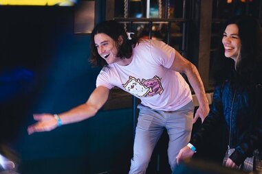 People playing skee-ball