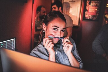 Person using dart as a mustache