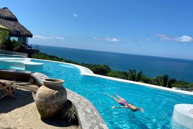 person floating in pool