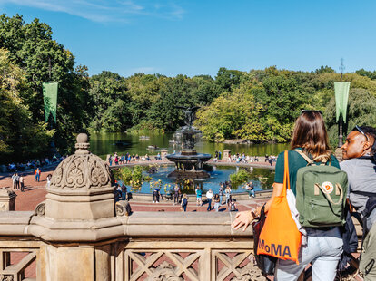 two visitors overlooking bethesda fountain in central park