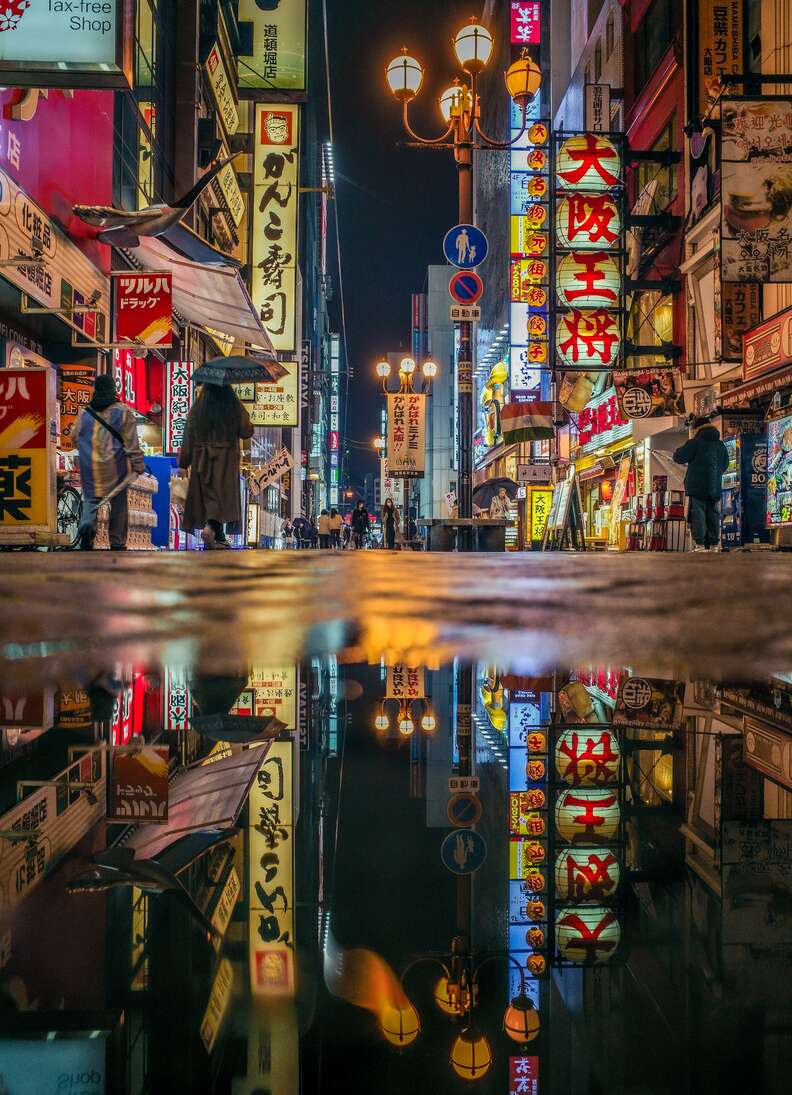 city street reflected in puddle