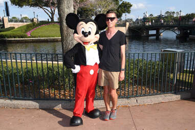 Man poses with Mickey