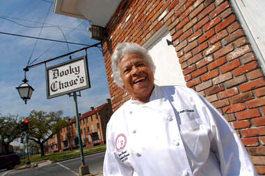 leah chase standing in front of dooky chase restaurant, new orleans
