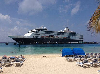 new victoria cruises cruise ship in front of a beach new experience live at sea for 27 months