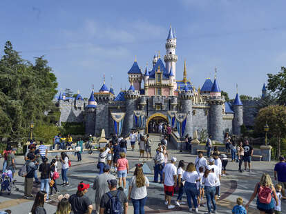 Visitors to Disneyland in front of Sleeping Beauty's castle in Anaheim, California