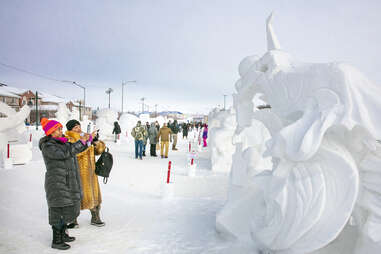 People looking at snow sculptures 