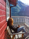 Woman sitting on deck of lake house