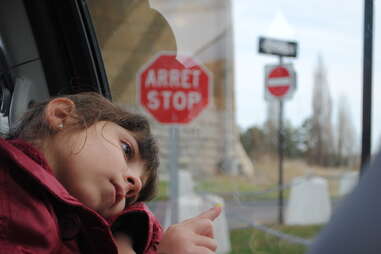 girl in car with arret sign 
