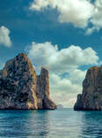 Large cliff rocks in the ocean off the coast of Capri, Italy. 