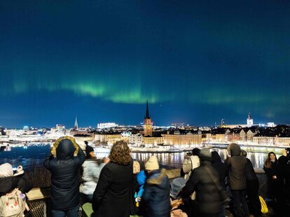 People gathered to watch the northern lights in central Stockholm, Sweden