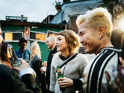 friends drinking and catching up at open air nightclub