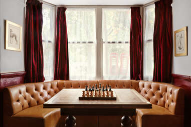 A chess game at a booth inside of the pub. 