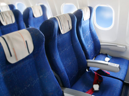 An empty row of seats on an airplane.