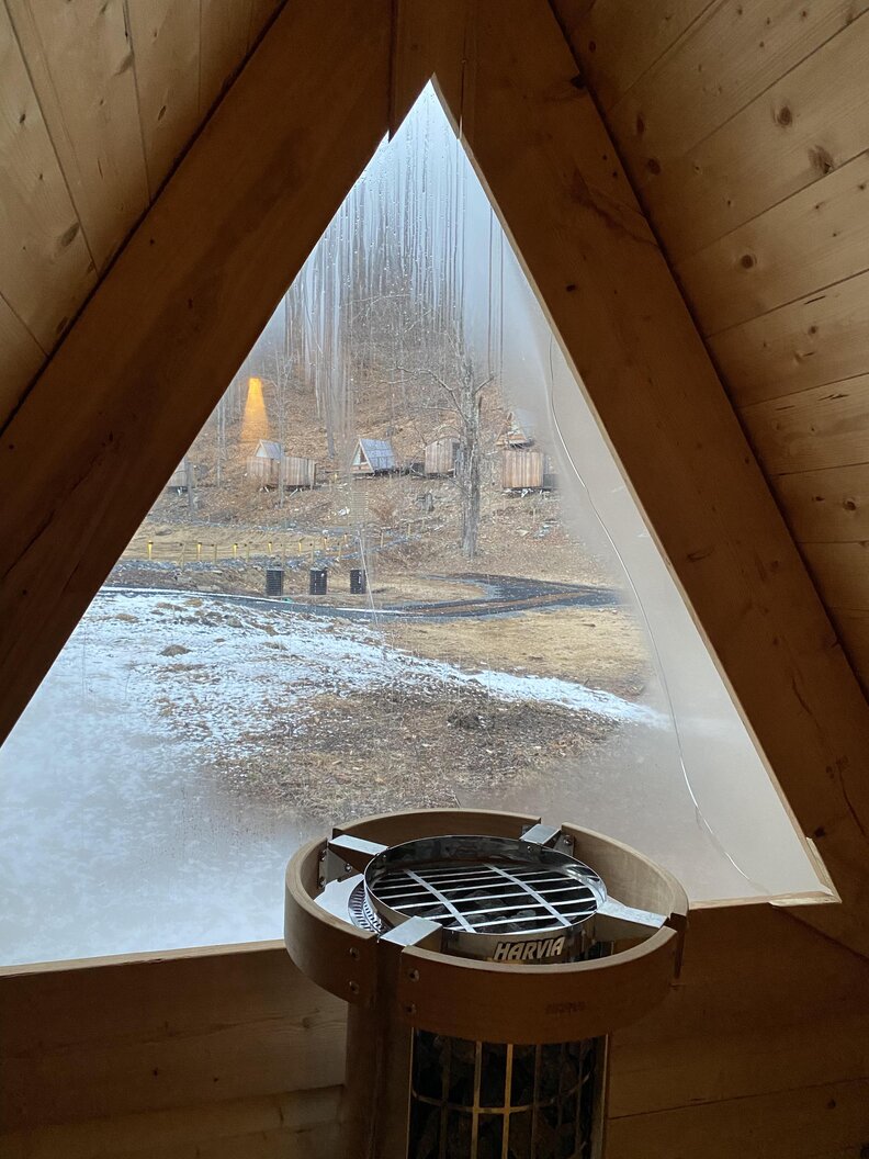The view through a window inside a cabin at the Eastwind Oliverea Valley Hotel