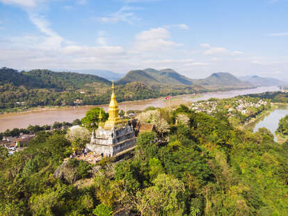 The golden pagoda of Wat Chom Si on the top of Mount Phou Si in Luang Prabang in Laos