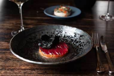 Trout tartare, yuzu, blood plum, and squid ink cracker at Stillwater Restaurant