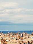 A crowded beach in Barcelona, Spain during the summer. 