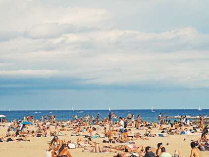 A crowded beach in Barcelona, Spain during the summer. 