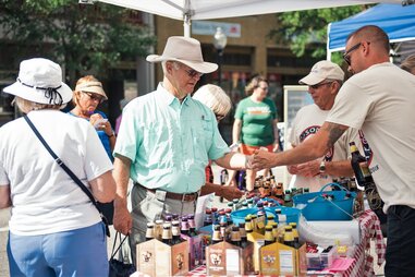 soda samples being handed across booth