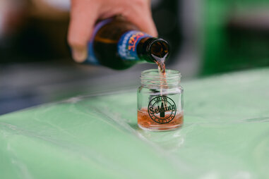 soda sample being poured into small cup
