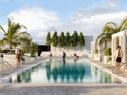 people walking by the pool at Arlo Wynwood