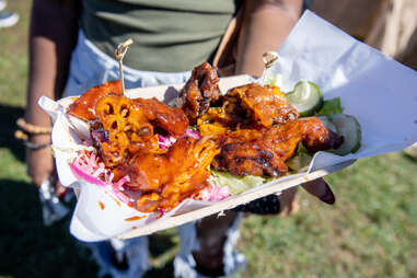 hand holding chicken plate at vegandale festival