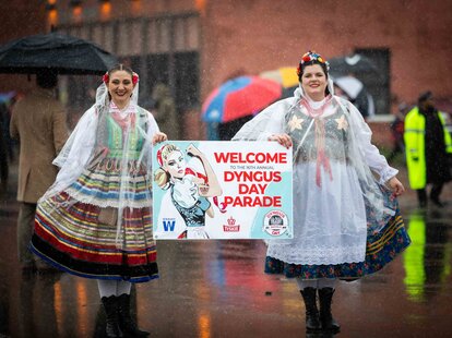 Two costumed women holding a sign at Dyngus Day Buffalo