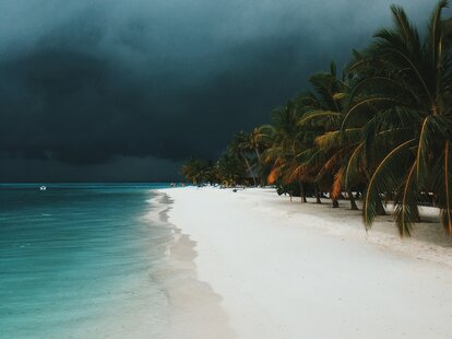 A thunderstorm arriving on a tropical beach.