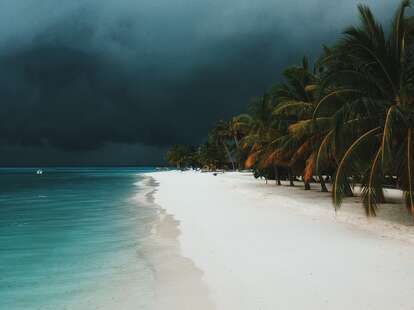 A thunderstorm arriving on a tropical beach. 