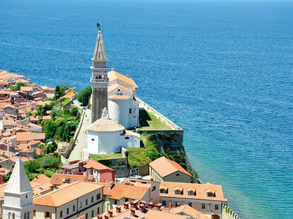 a cliffside building in Slovenia, overlooking the sea.