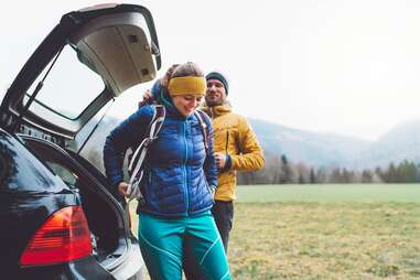 Hikers standing by car