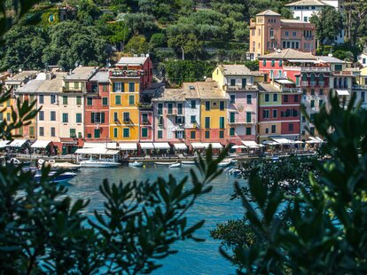 A view of the coastline in Portofino, Italy featuring colorful buildings.
