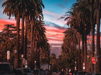 The Hollywood sign in Los Angeles, California during a very pink sunset.