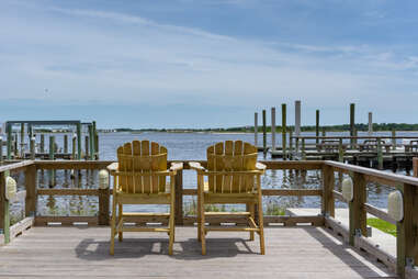 two lounge chairs on a dock overlooking water, swansboro, north Carolina