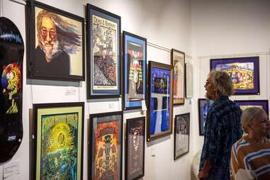 people looking at pyschedelic poster art