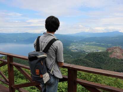 Man looking at view of Lake Toya in Hokkaido, Japan