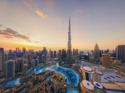 An aerial view of the Burj Khalifa in Dubai at sun set.