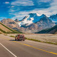 car driving along scenic icefields parkway in alberta, canada